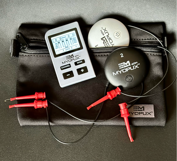 An image of the MyoPux eDN device which includes a wireless controller, wires with Pomona clips, and multiple Pux units in black and white colors.